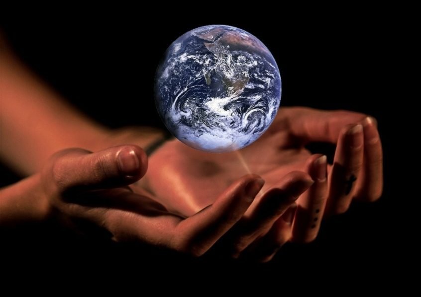 Hands holding world representing international patent filing